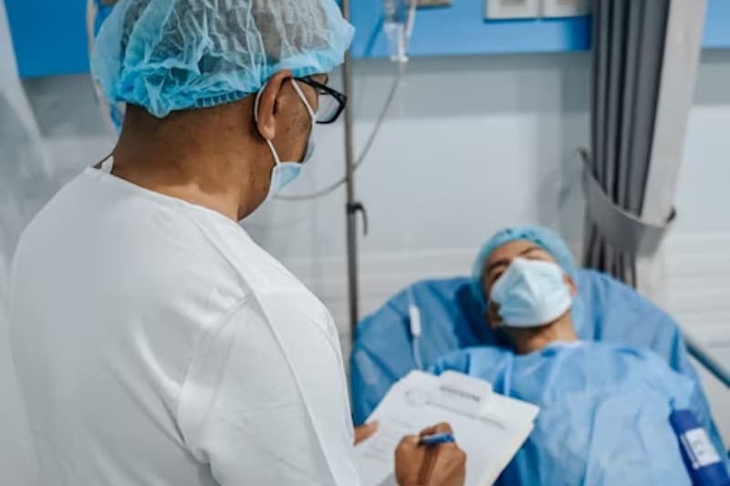 A healthcare worker taking down notes with a patient in a hospital setting